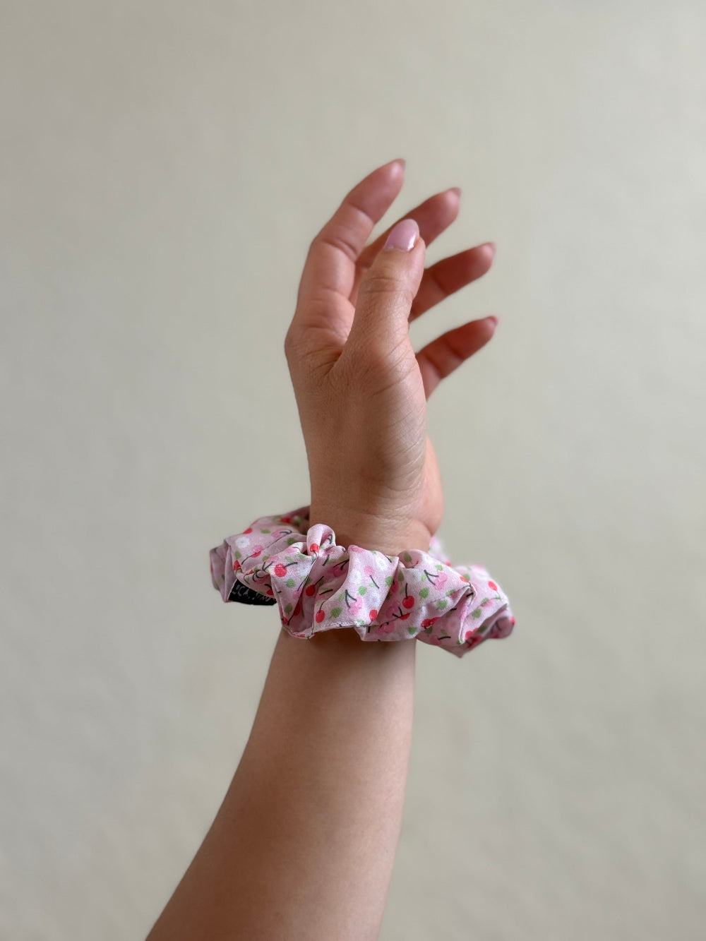 Amy mini scrunchie in pink cherry print made from 93% polyester and 7% elastane, perfect for short or fine hair with a soft, stylish hold.