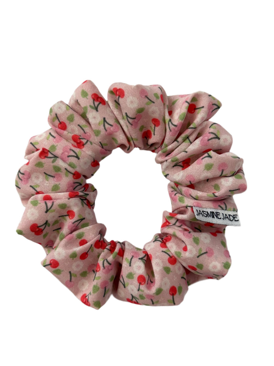 Amy XS scrunchie in pink cherry print, designed for delicate styles and short hair, with a soft and playful finish.