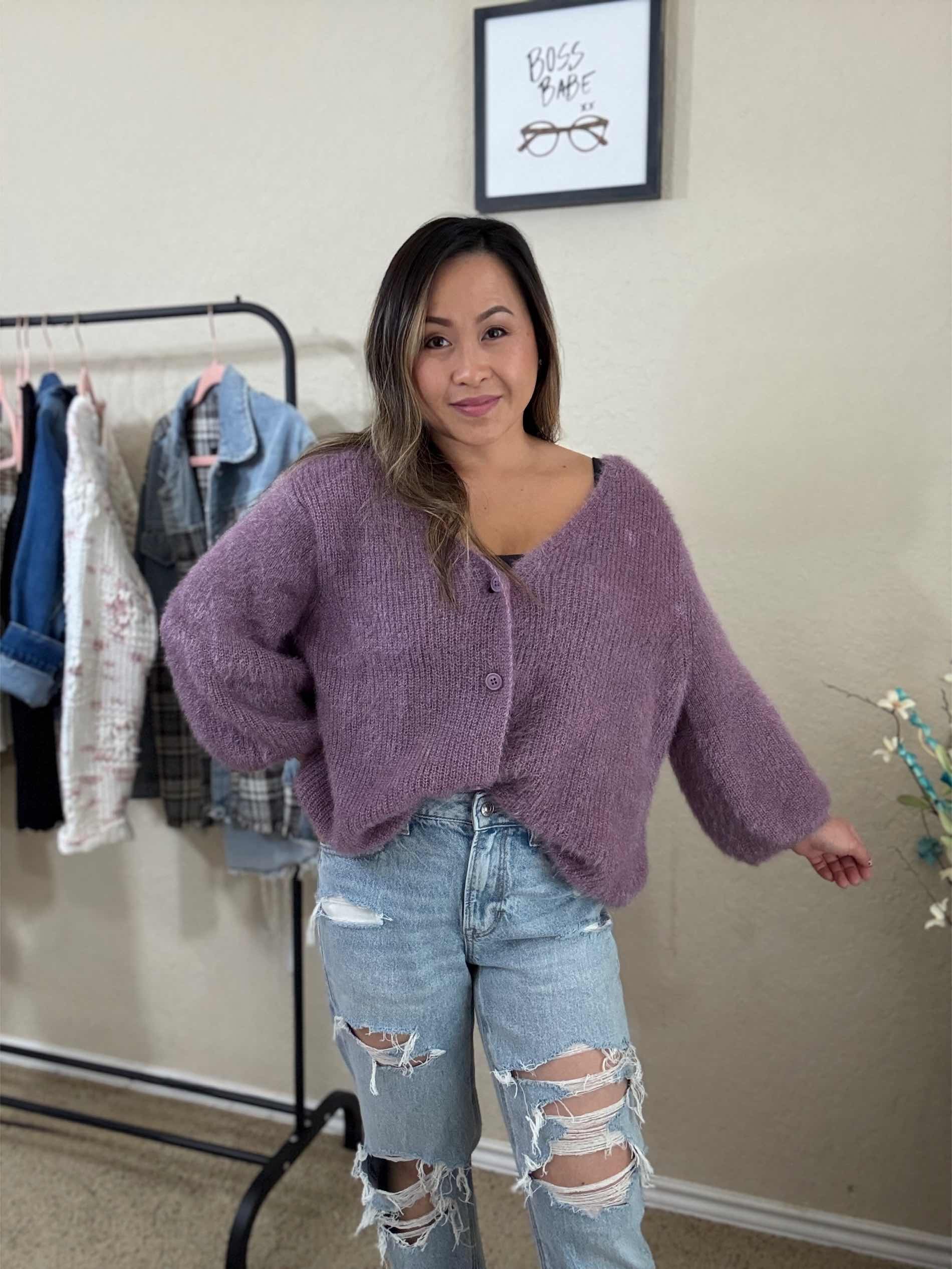 Front view of a woman wearing a lavender soft knit cardigan with button-front closure, oversized and fluffy design, showing voluminous sleeves.